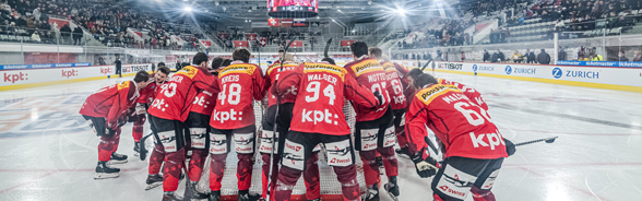 The Swiss national ice hockey team confers during a match.