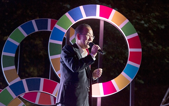 The UN Secretary General, a South Korean national, speaking into a microphone 