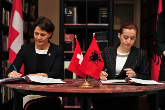 Ambassador Ruth Huber with Albania's Deputy Prime Minister Senida Mesi signing two project agreements. 