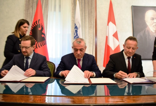 OSCE Secretary General Thomas Greminger with Albania's Speaker of Parliament Gramoz Ruçi and Swiss Ambassador Christoph Graf signing agreement for the new support project. © 