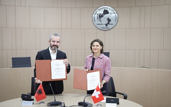 Albania's State Commissioner for Elections Ilirjan Celibashi and Swiss Ambassador Ruth Huber after signing agreement on new cooperation for improved effectiveness of the Central Elections Commission. 