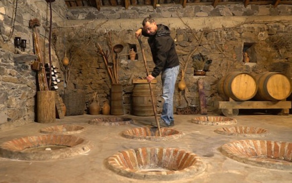 a local farmer in his wine cellar