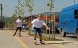 Two young people rollerblading on a cycle path..