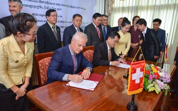 H.E. Dr. Phouang Parisak Pravongviengkham, Deputy Minister of Agriculture and Forestry and Mr. Tim Enderlin, Director of Cooperation for the Mekong Region of the Swiss Agency for Development and Cooperation (SDC) at the SURAFCO signing ceremony. 