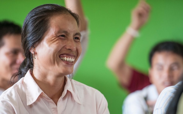 A local woman smiling broadly.