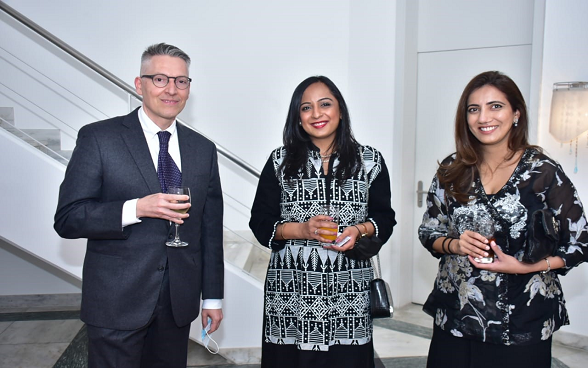 Mr Alberto Groff Deputy Head of Mission of Switzerland with guests at a reception