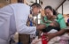 Zuena Hussein Ismail with her baby attended by a health worker at Makole Health Centre in Dodoma.