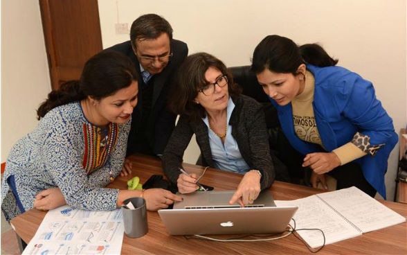 Jennifer Duyne Barenstein, the Swiss expert, discusses with colleagues in front of a computer