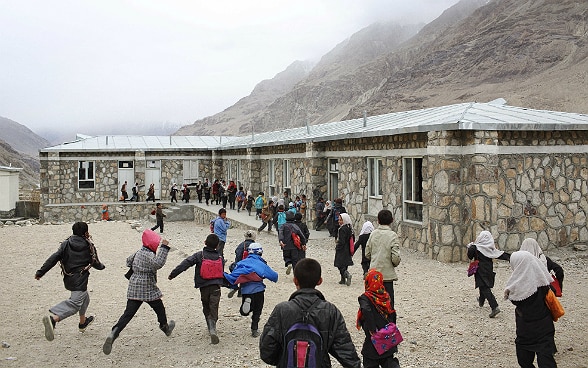 Un groupe d’enfants se dirige vers une école dans une région de montagne.