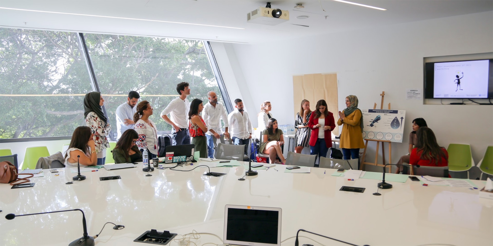 A group of journalists gathered around an instructor.