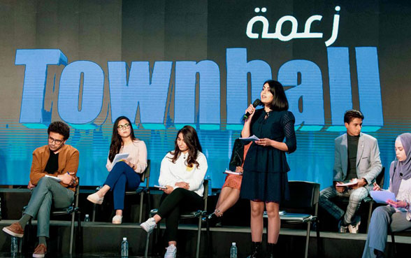 Young people discuss at a round table on television.