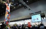 A big multi-coloured tree stands above the visitors to the African Book Fair.