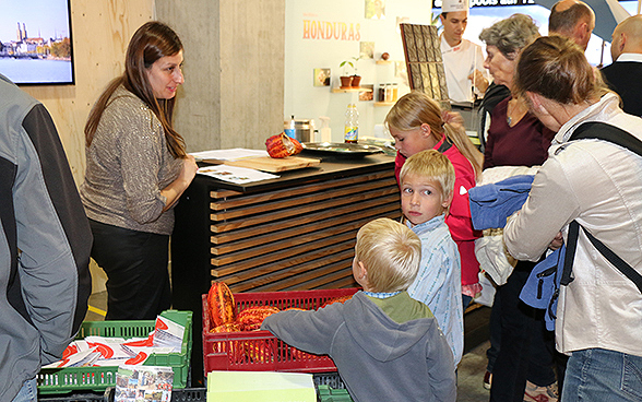 Children and adults at the Honduras stand in the SDC's special exhibition for OLMA 2015.