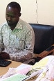 Sitting at his desk, a Hargeisa municipal employee enters paid bill details into a computer system.