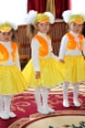 Five young girls in yellow costumes at the opening ceremony of the new kindergarten
