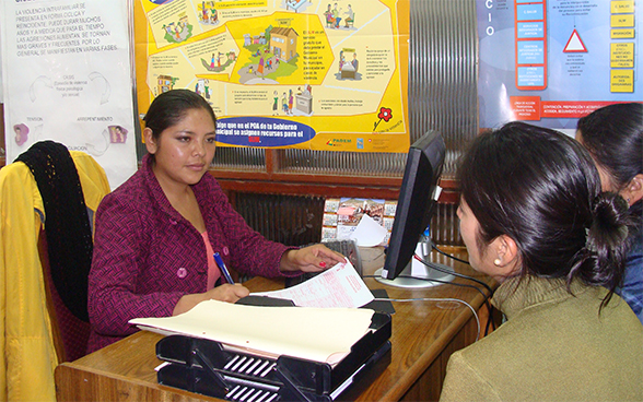 Two women engaged in a discussion with a psychologist at a counselling centre
