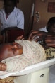 A baby being weighed in a consultation room.