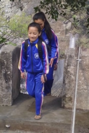 Two students use the reconstructed trail bridge.