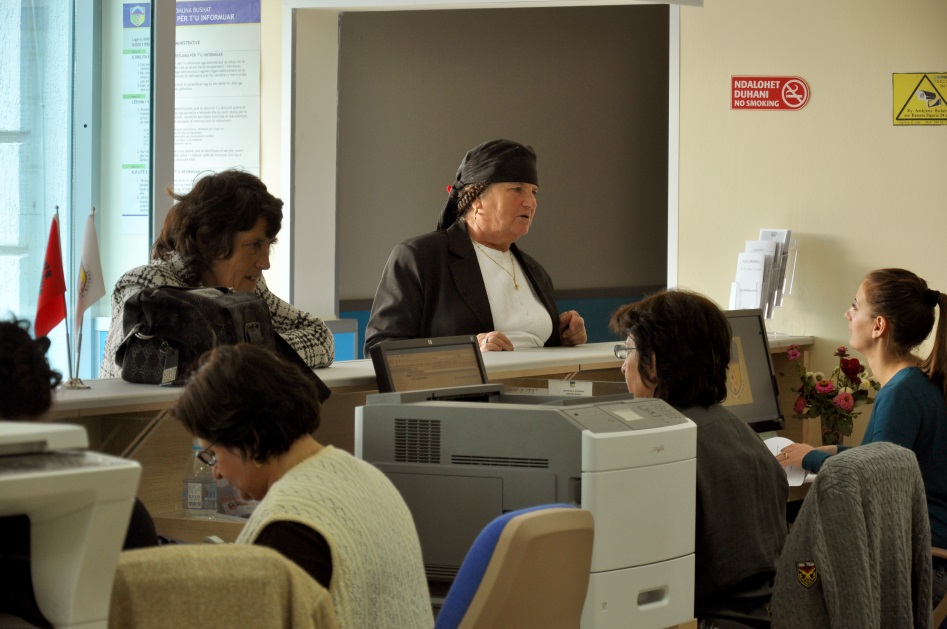 Des femmes se rendent au bureau de la commune de Bushat.