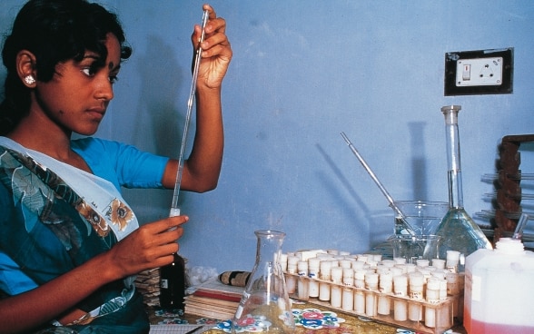 A woman researcher checking a test.