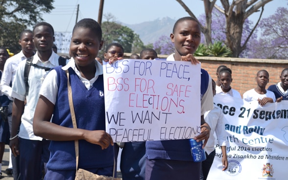 Young people demonstrate with placards calling for peace and peaceful elections in Malawi.