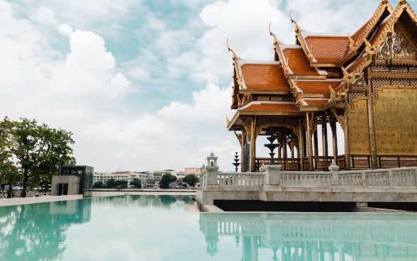 Peaceful water near a historical temple in Bangkok.