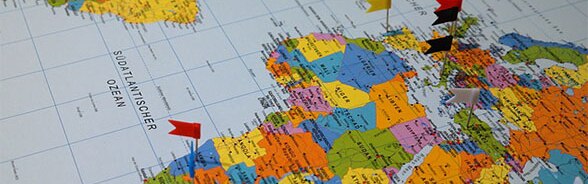 World map with little flags marking destinations
