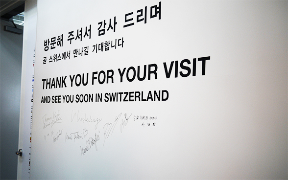 Photo d'un mur d'exposition du pavillon suisse en Corée en 2012 portant des inscriptions