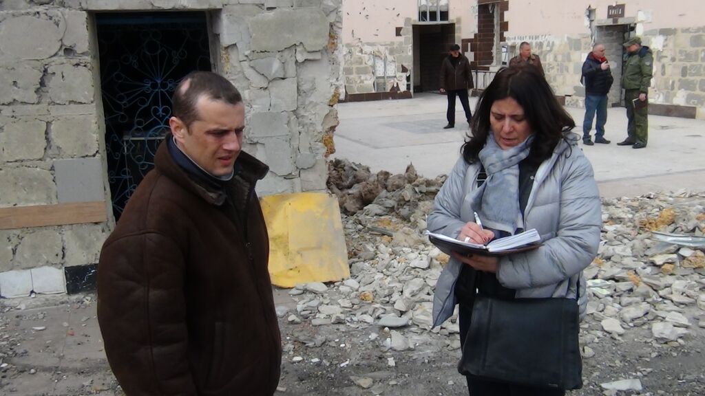 A member of the Office of the High Commissioner for Refugees collects the testimony of an injured prisoner in the Donetsk region.  