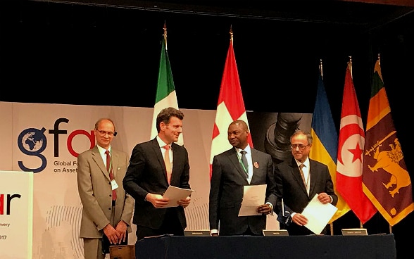 L' Ambasciatore svizzero Roberto Balzaretti, il Ministro della giustizia nigeriano Abubakar Malami e Rachid Benmessaoud, capo della Rappresentanza della Banca mondiale ad Abuja, dopo la firma dell' accordo.