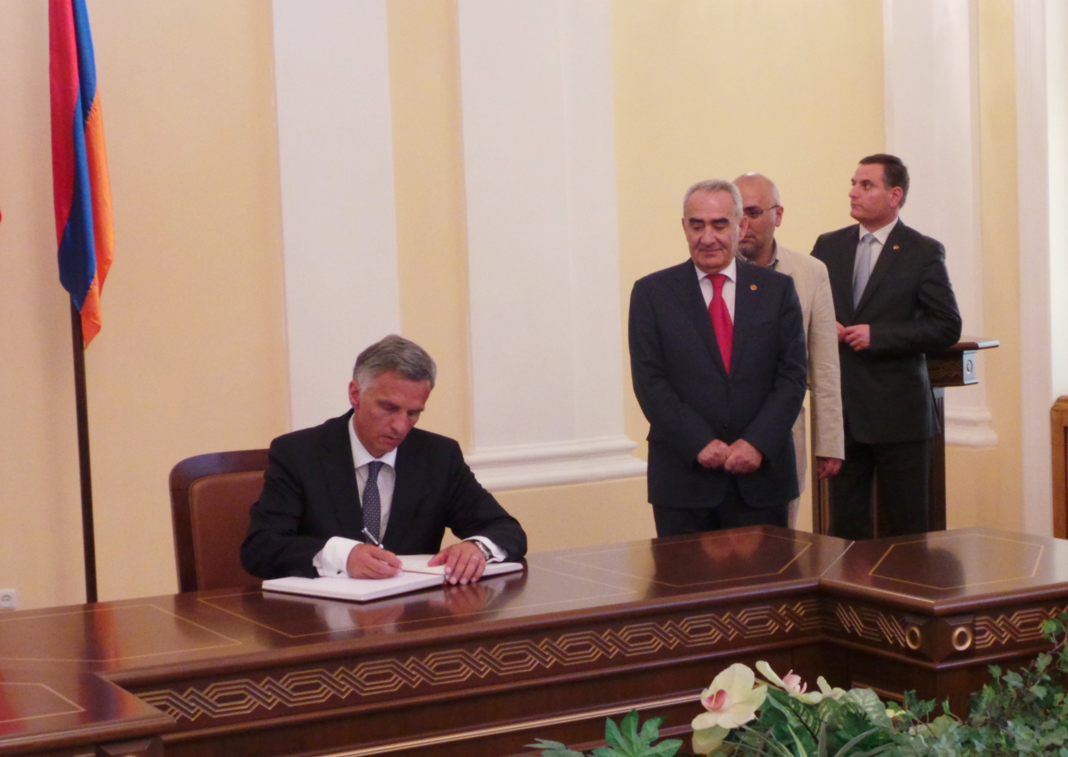 Bundespräsident Didier Burkhalter trägt sich nach einem Gespräch mit Parlamentsmitgliedern ins Gästebuch des armenischen Parlaments ein. Rechts neben ihm: Parlamentspräsident Galust Sahakyan.