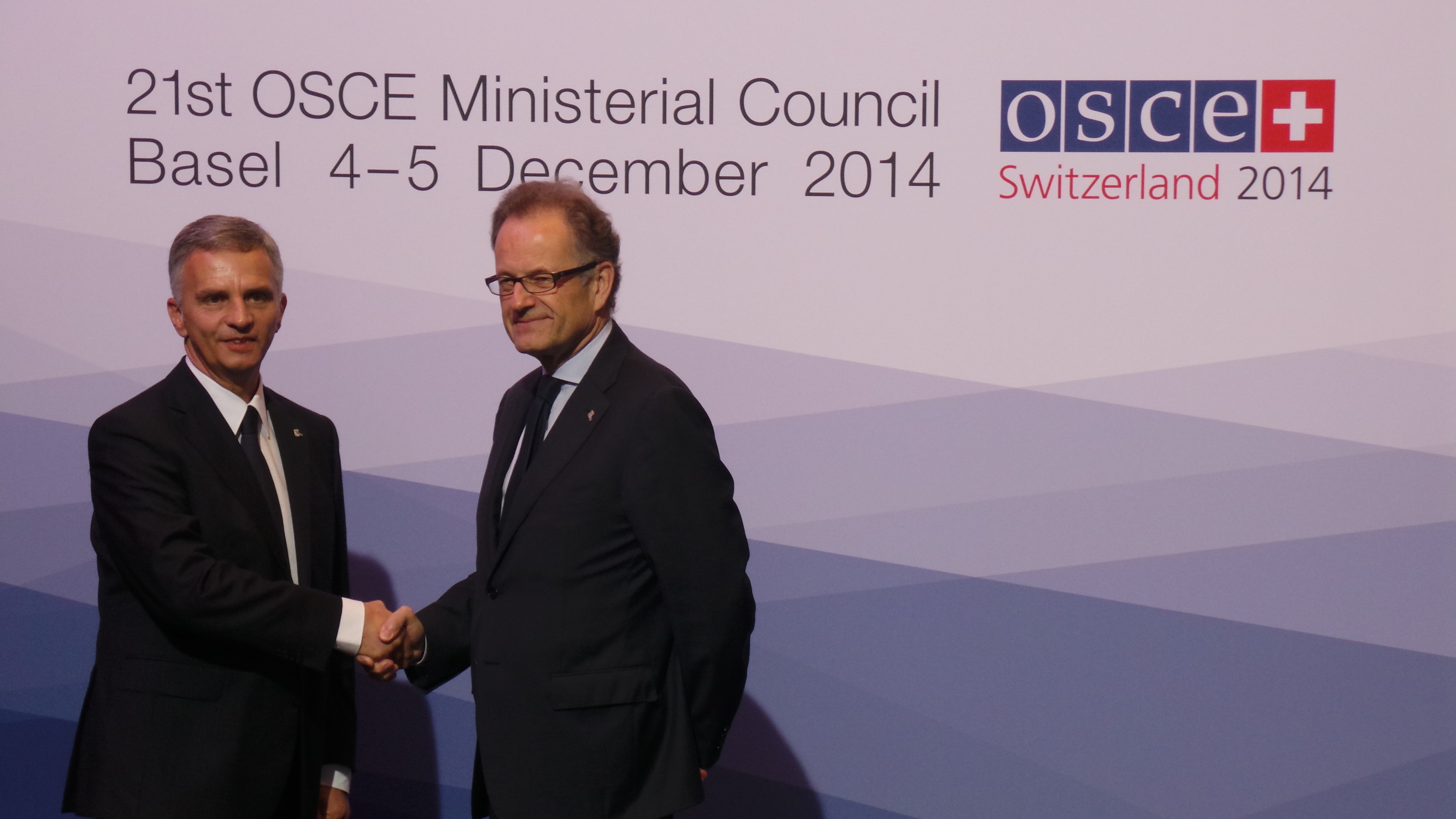 The President of the Swiss Confederation, Didier Burkhalter, greets Michael Møller, Acting Director-General at the United Nations office at Geneva at the OSCE Ministerial Council 2014 in Basel