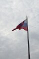 The Swiss, Slovakian and EU flags flying in the wind.