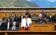 Surrounded by a group of young diplomats, the Apostolic Nuncio addresses the diplomatic corps.