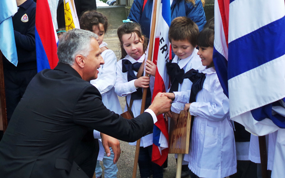 Bundesrat Didier Burkhalter begrüsst Schulkinder aus Nueva Helvecia. © EDA