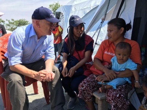 Ambassador Manuel Bessler, Head of Swiss Humanitarian Aid, talks with a woman, whose family was affected by the earthquakes and tsunami of 28 September