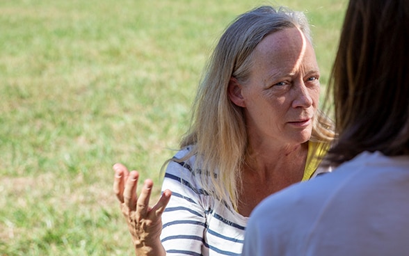 Ellen Milnes, in the foreground, answers questions during an interview.