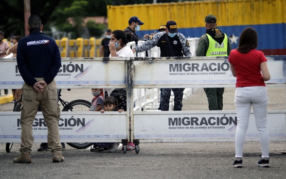 A family crosses the Simon Bolivar international bridge from Venezuela to Colombia, after the opening of a humanitarian corridor, in Cucuta, Colombia.