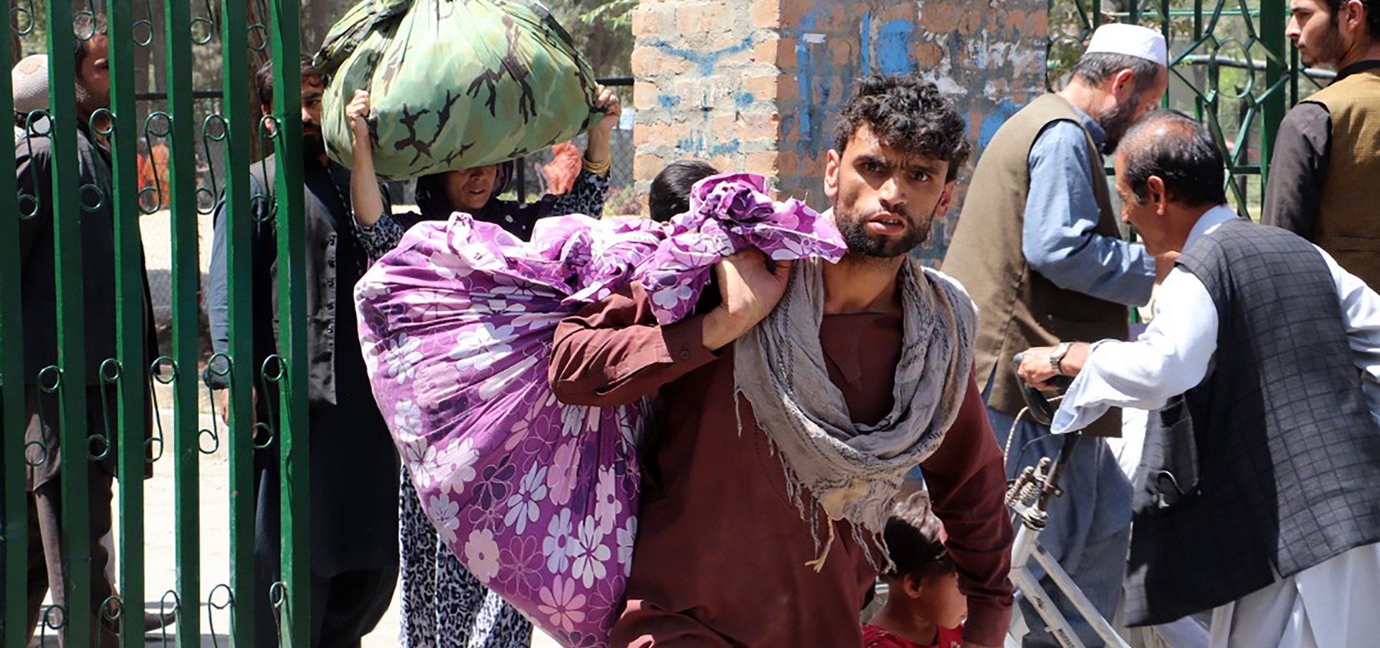 A man in Kabul carrying his few belongings in a makeshift sack.