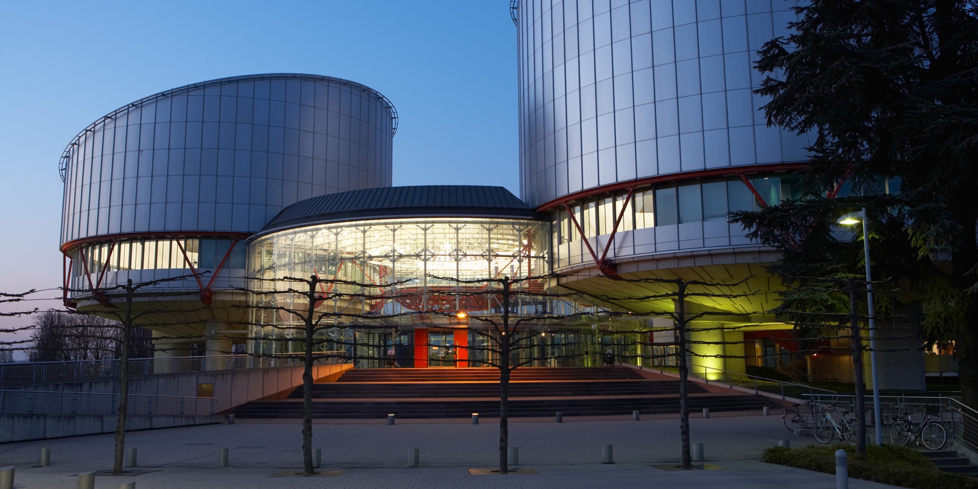 Exterior of the European Court of Human Rights building in the evening. 