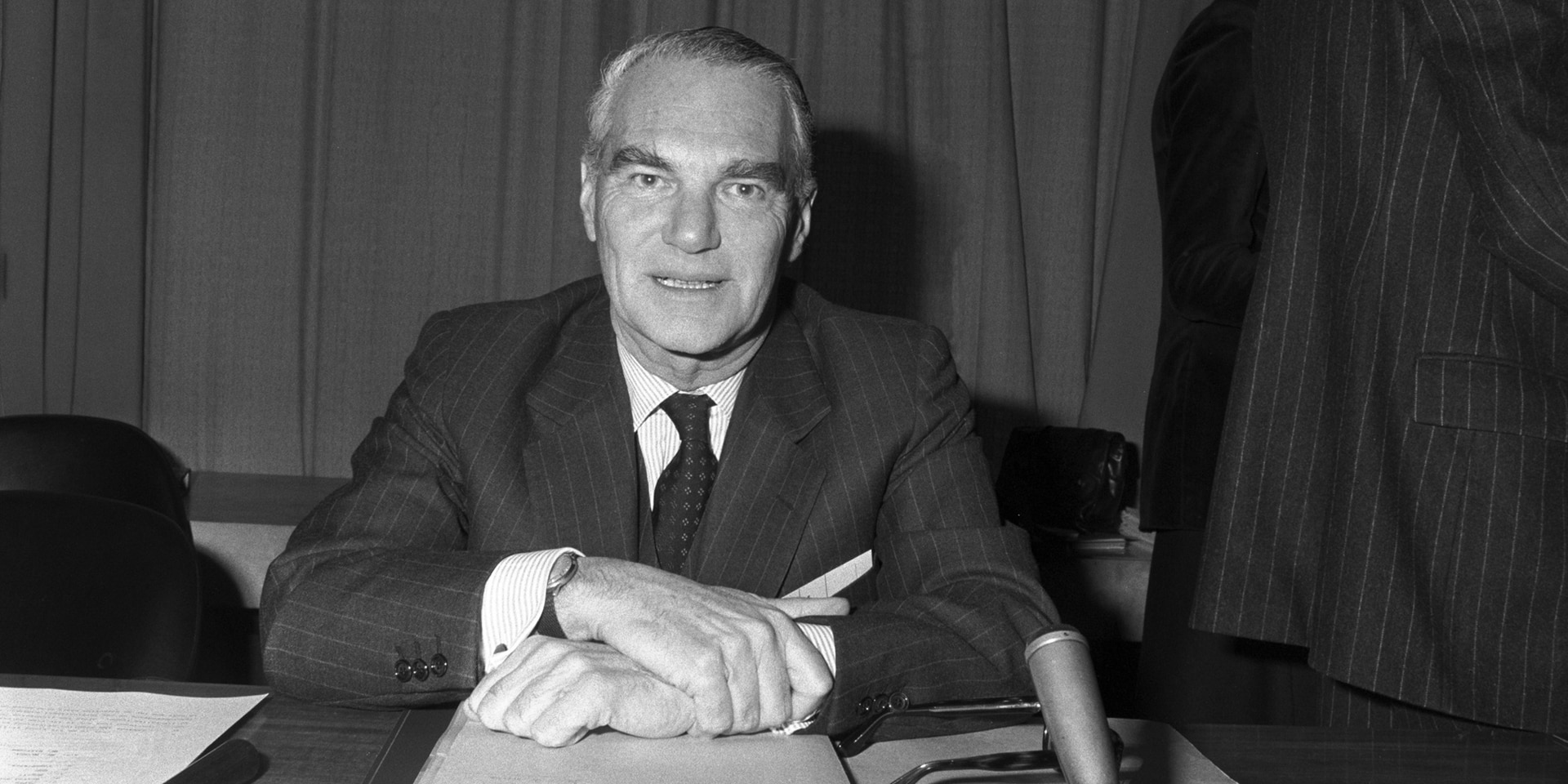 Portrait of Olivier Long, sitting at his desk.