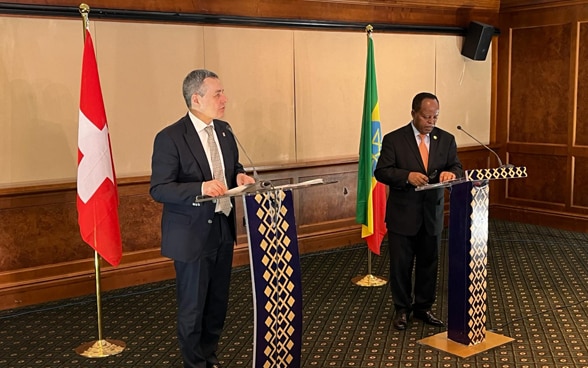 Ignazio Cassis and Taye Atske Selassie stand in front of a lectern.