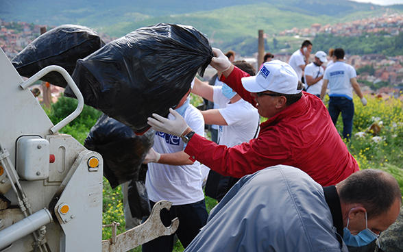 Rubbish collected in the natural surroundings of Pristina is disposed of by members of the OSCE mission