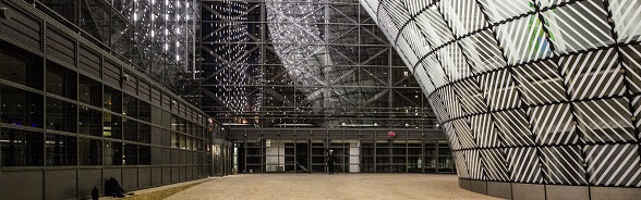 The contemporary interior of the Europa building in Brussels. The walls and facade are made of wood and glass.