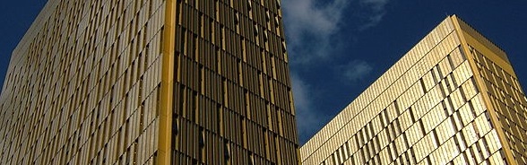 The Court of Justice of the European Union in Luxembourg with its golden towers shimmering against a blue sky.