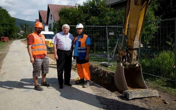 An excavator digging a trench for sewerage pipes.